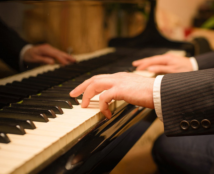A man's hands playing the piano