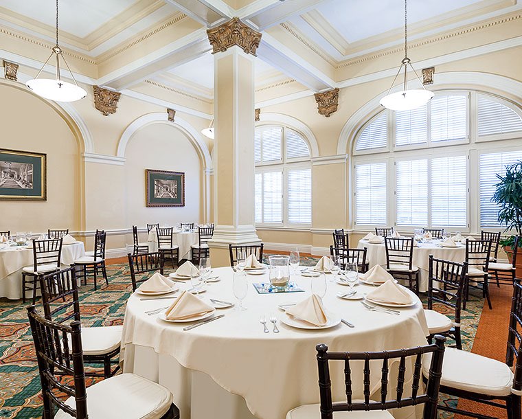 white circular tables in a parlor room with dining setup